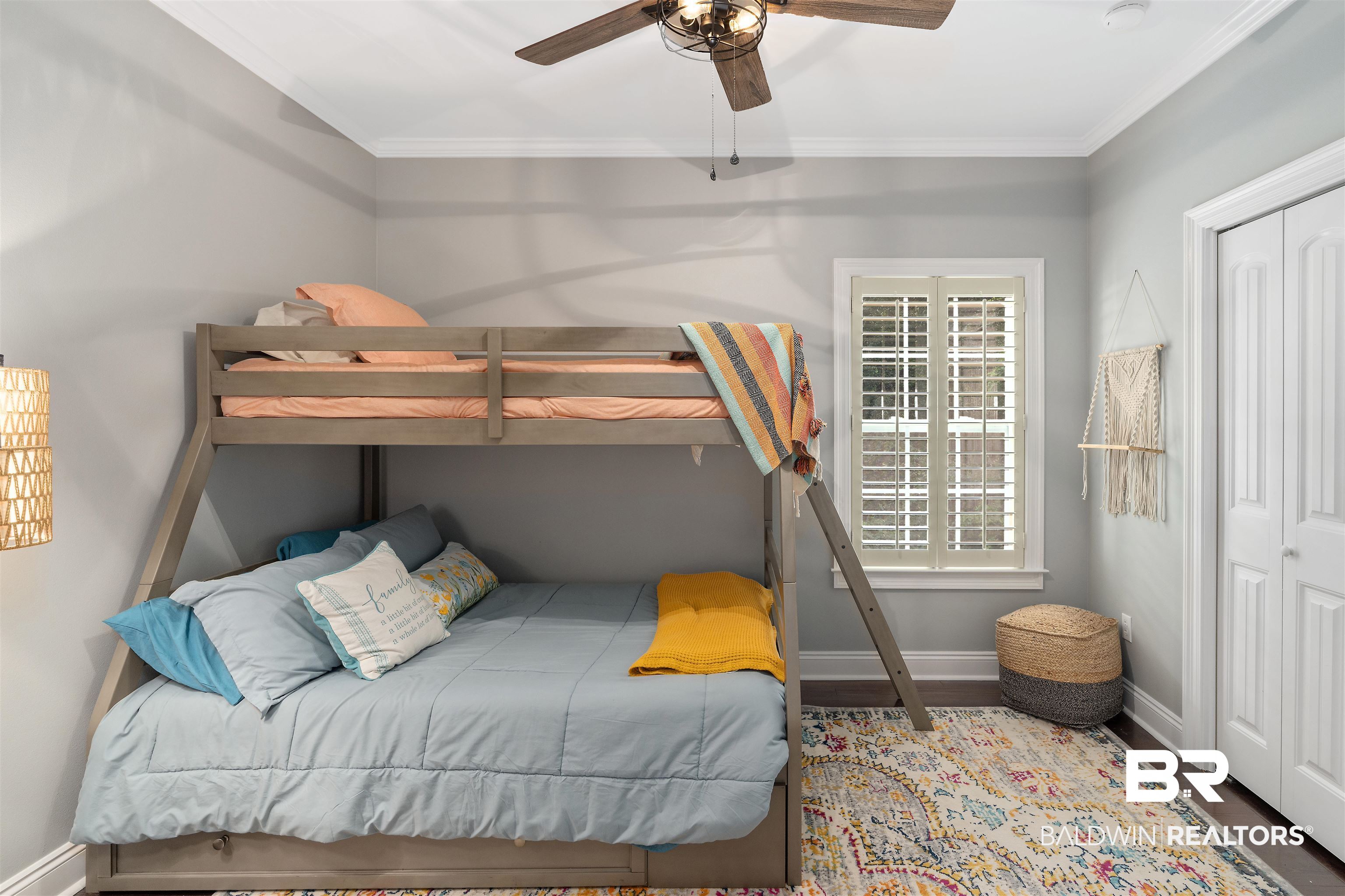 25591 Waterworld Road Robertsdale, AL 36567 - Photo 22 of 33 Bedroom with a closet, ceiling fan, wood-type flooring, and crown molding