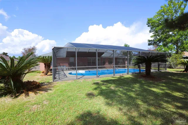 a view of a house with backyard and sitting area