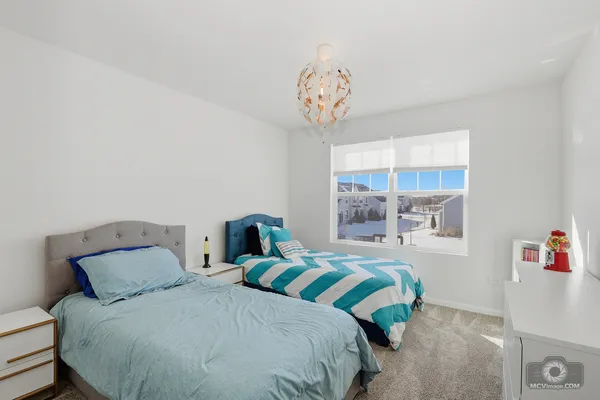a bedroom with a bed and a chandelier