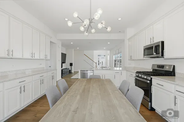 a large white kitchen with cabinets
