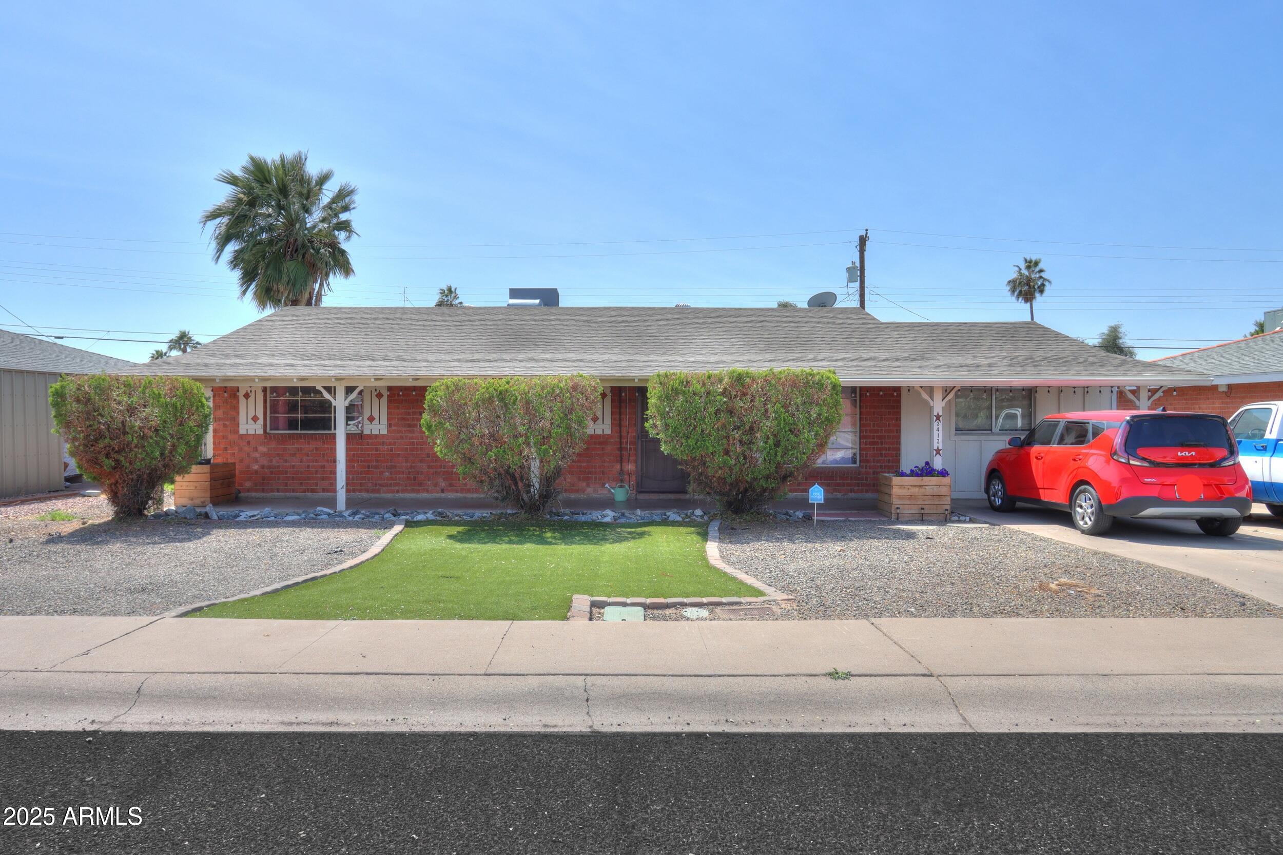 3413 West Ocotillo Road Phoenix, AZ 85017 - Photo 1 of 29 a front view of a house with a yard and garage