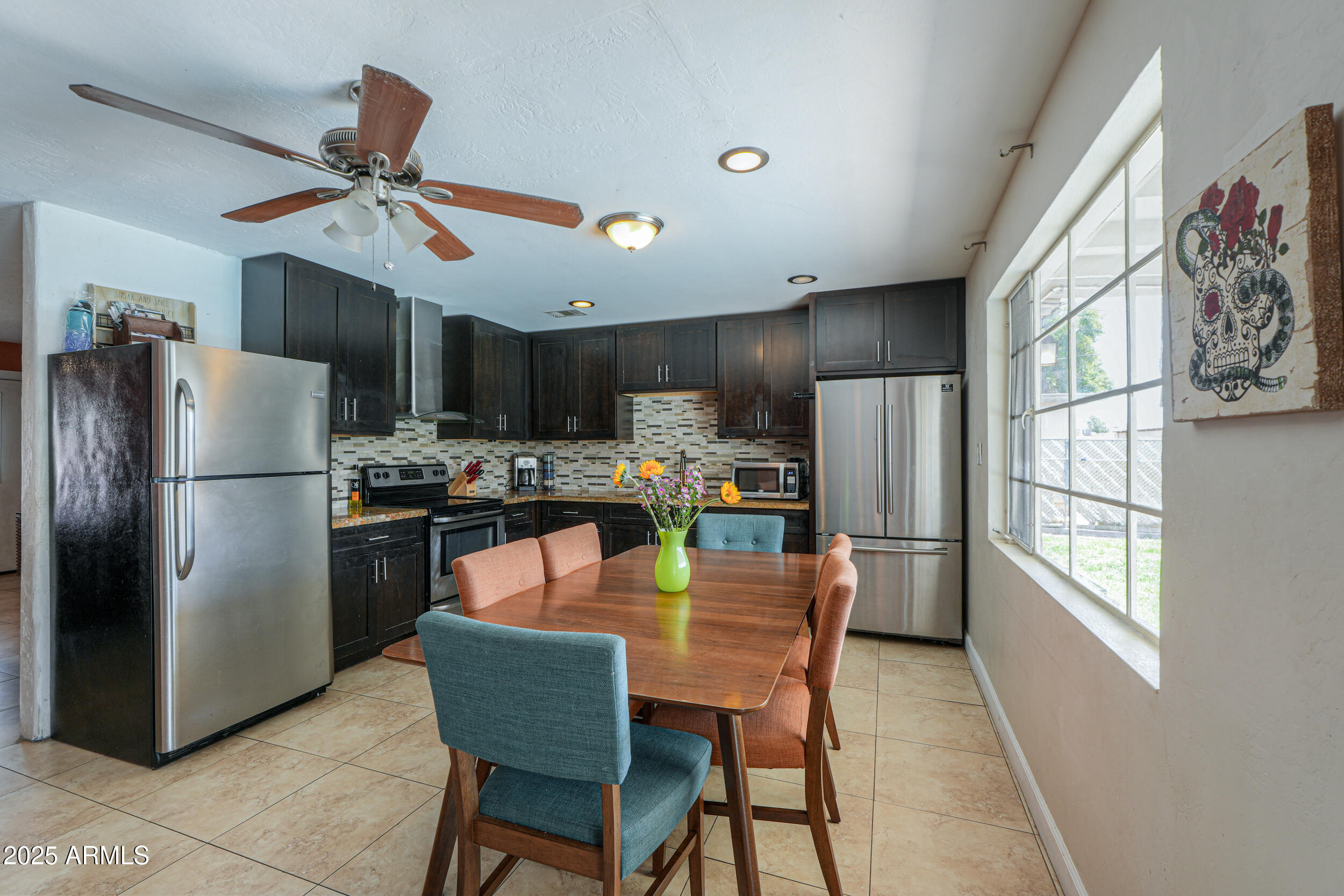 3413 West Ocotillo Road Phoenix, AZ 85017 - Photo 11 of 29 a kitchen with stainless steel appliances granite countertop a refrigerator a sink dishwasher a stove and a refrigerator with wooden floor