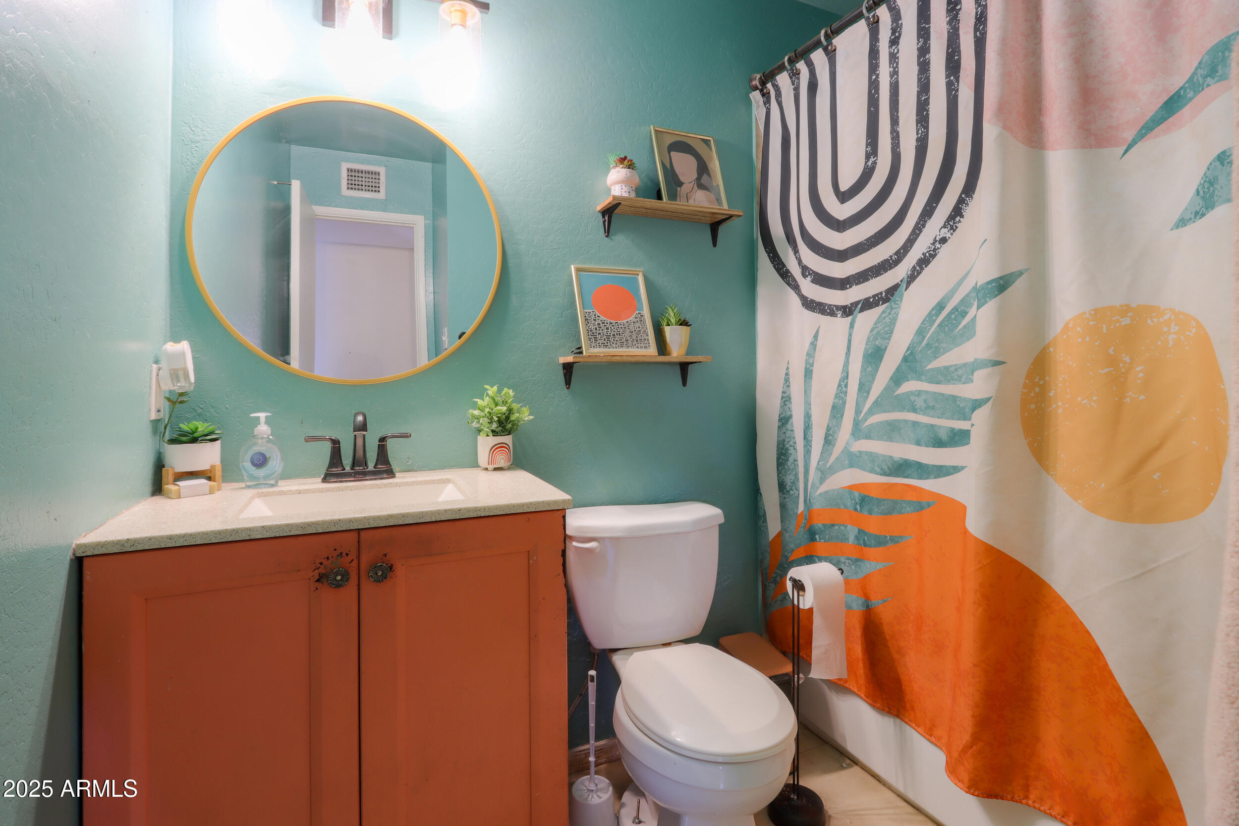 3413 West Ocotillo Road Phoenix, AZ 85017 - Photo 17 of 29 a bathroom with a toilet a sink and a mirror