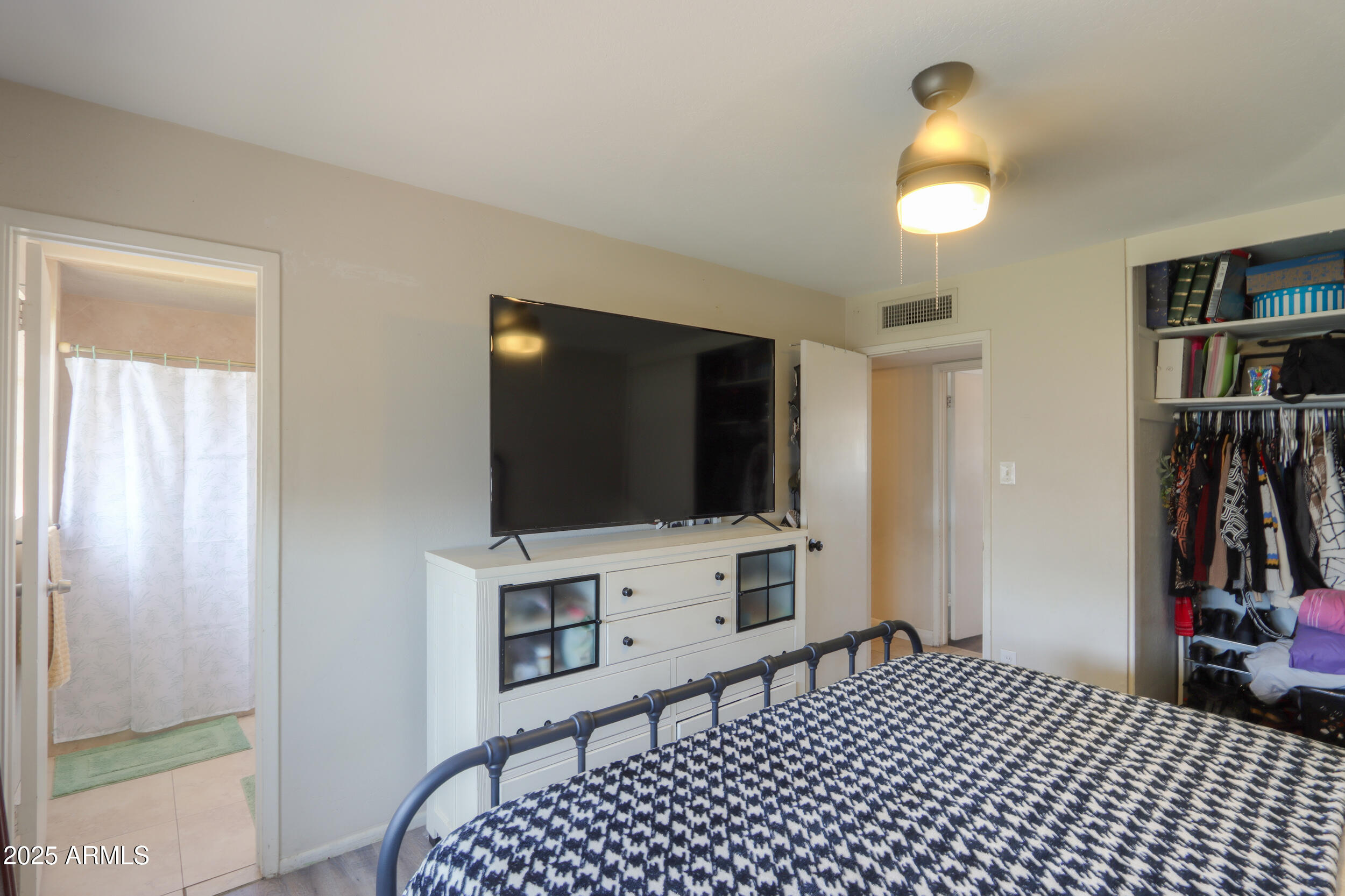 3413 West Ocotillo Road Phoenix, AZ 85017 - Photo 20 of 29 a bedroom with a bed and a flat screen tv