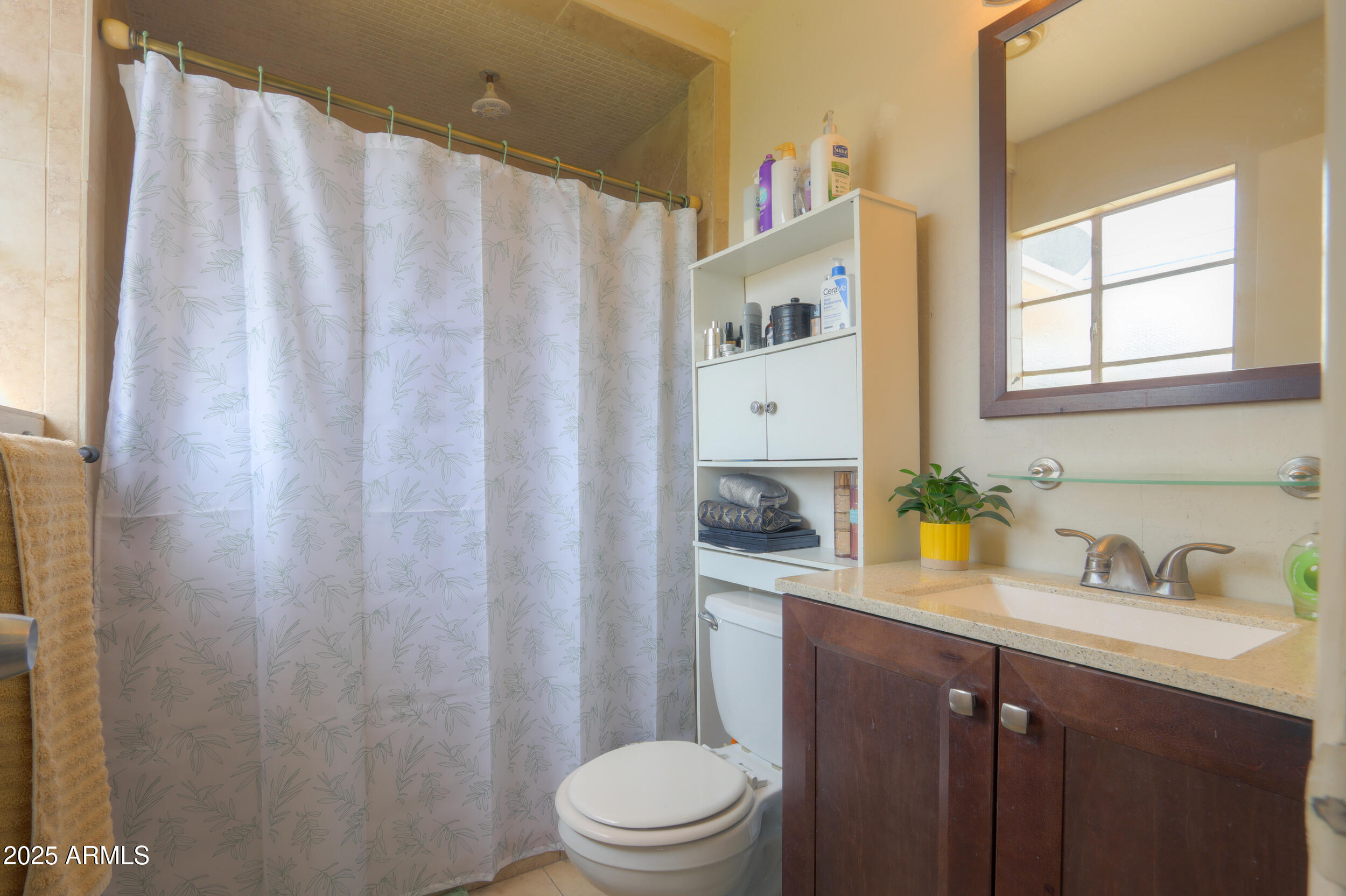3413 West Ocotillo Road Phoenix, AZ 85017 - Photo 21 of 29 a bathroom with a sink a toilet and shower curtain