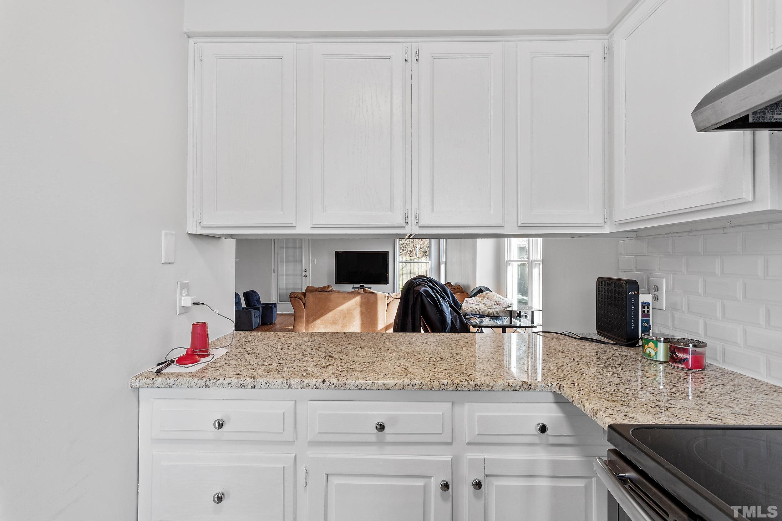 4416 Roller Court Raleigh, NC 27604 - Photo 22 of 33 a kitchen with granite countertop a sink and cabinets