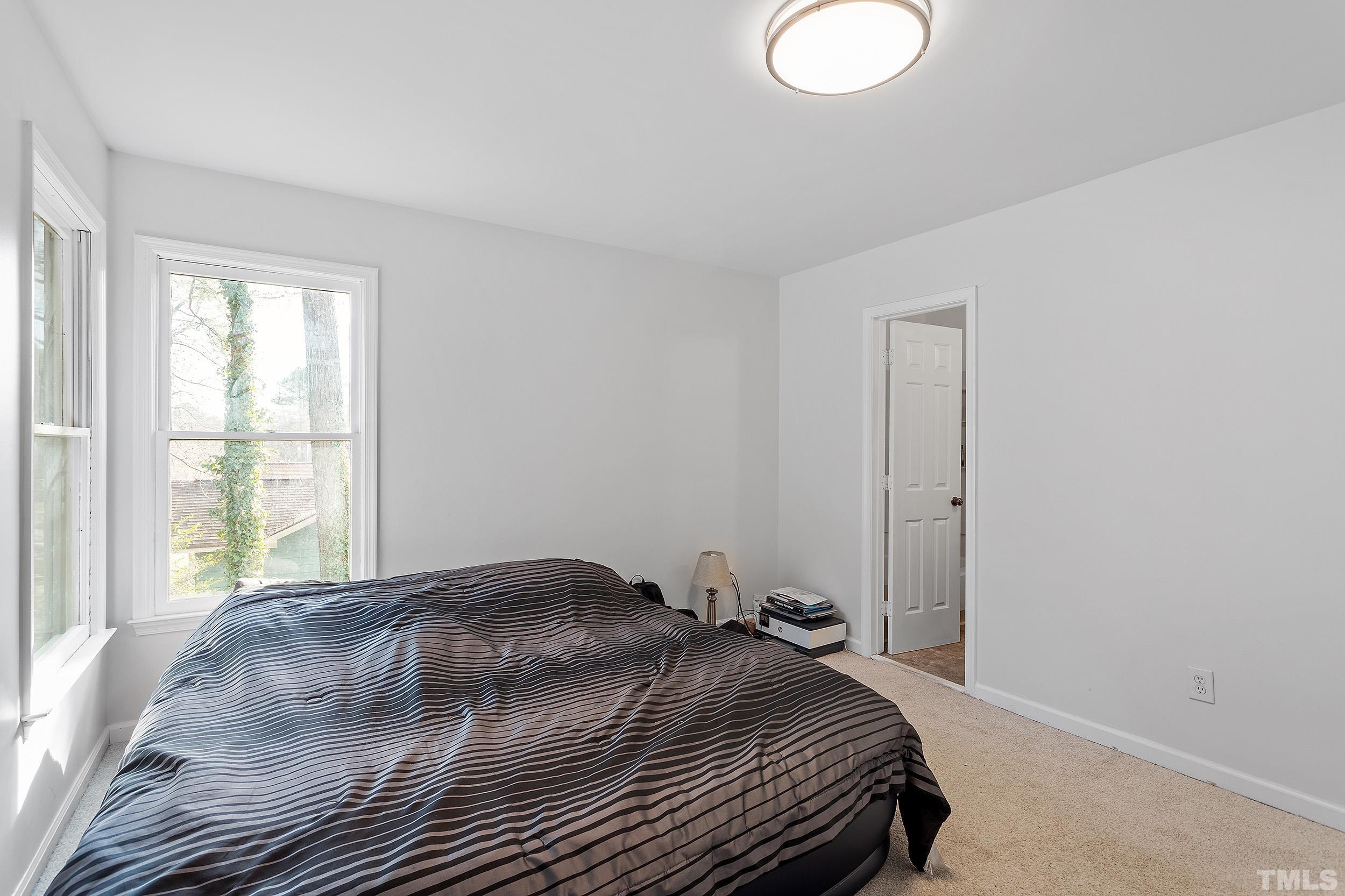 4416 Roller Court Raleigh, NC 27604 - Photo 24 of 33 a bedroom with a bed and a window