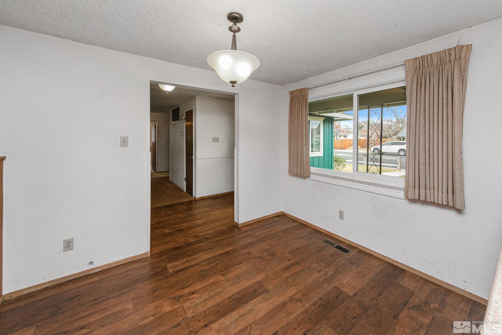 2300 Balsam Street Reno, NV 89509 - Photo 18 of 40 a view of an empty room with wooden floor and a window