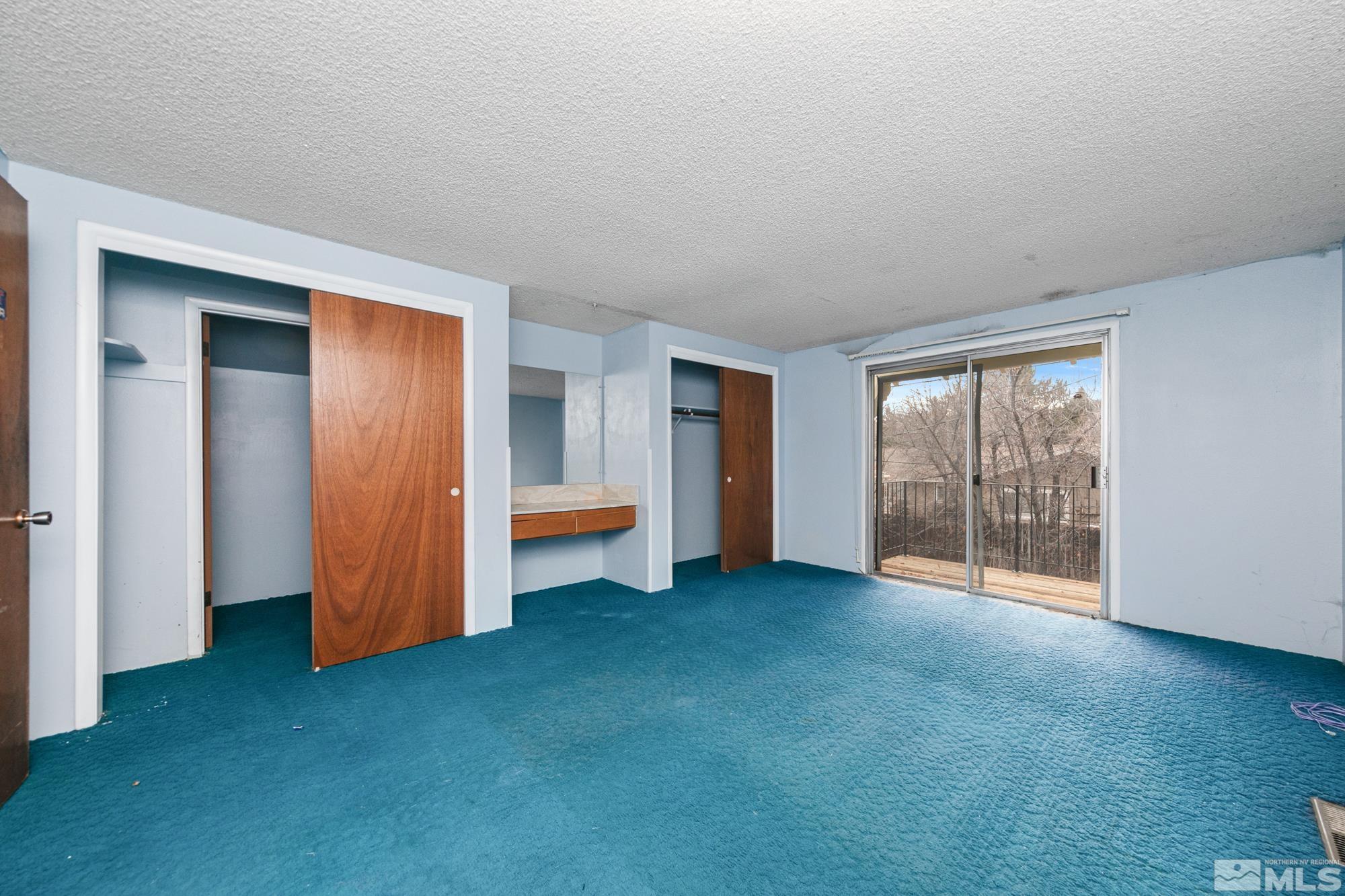 2300 Balsam Street Reno, NV 89509 - Photo 19 of 40 an empty room with a fireplace and window
