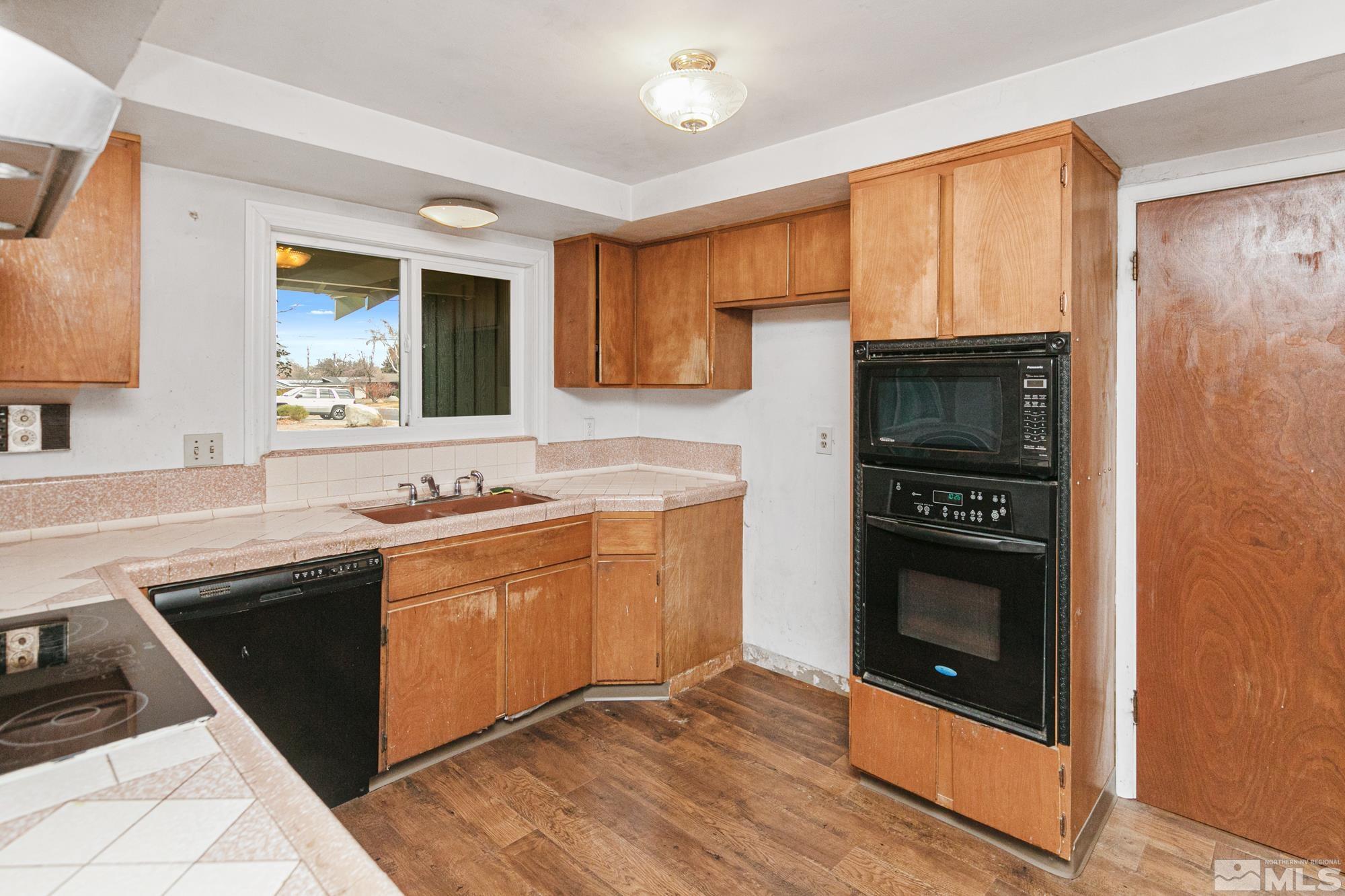 2300 Balsam Street Reno, NV 89509 - Photo 6 of 40 a kitchen with stainless steel appliances granite countertop a stove a sink and a microwave