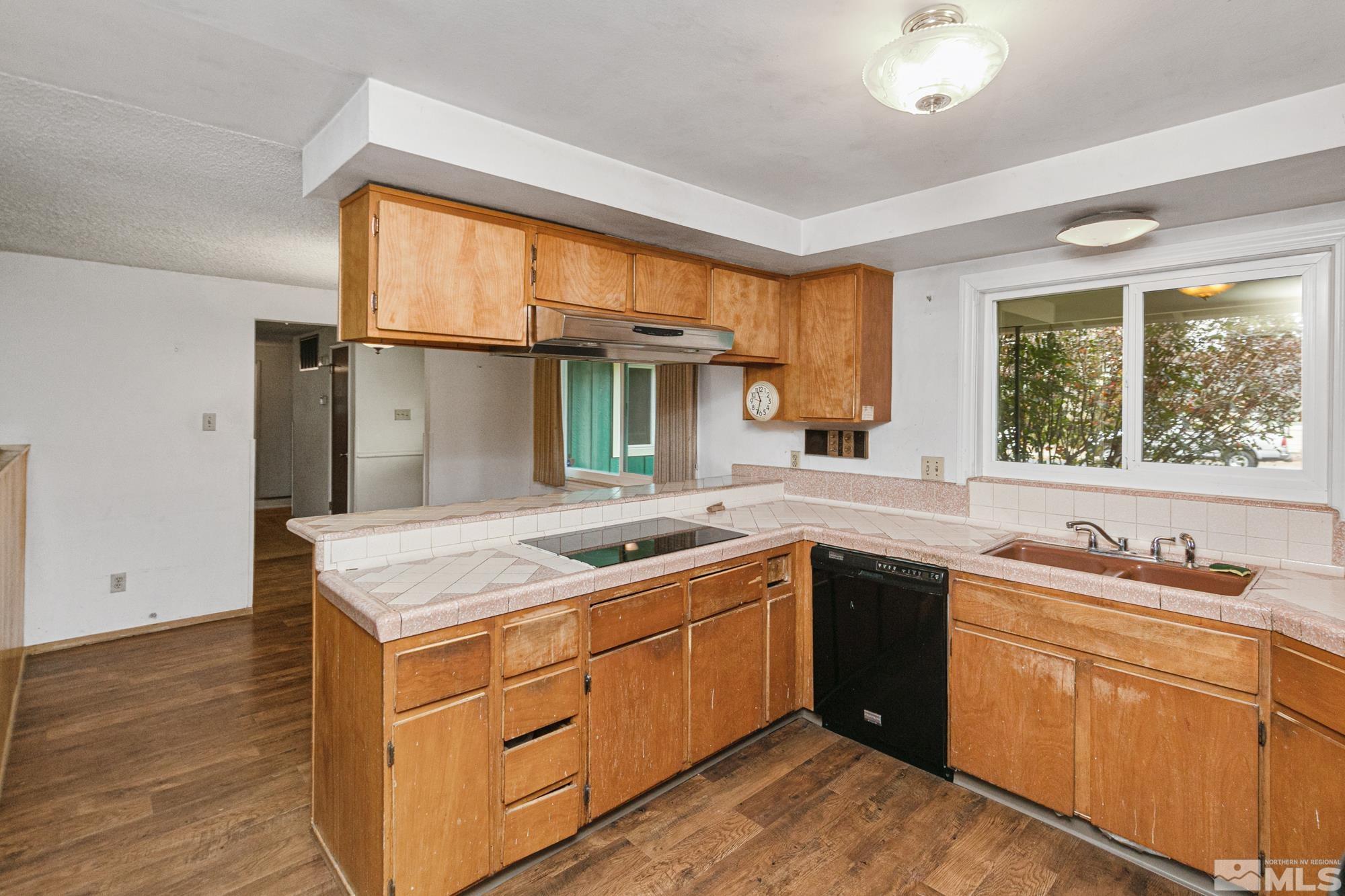 2300 Balsam Street Reno, NV 89509 - Photo 7 of 40 a kitchen with a sink stove and cabinets