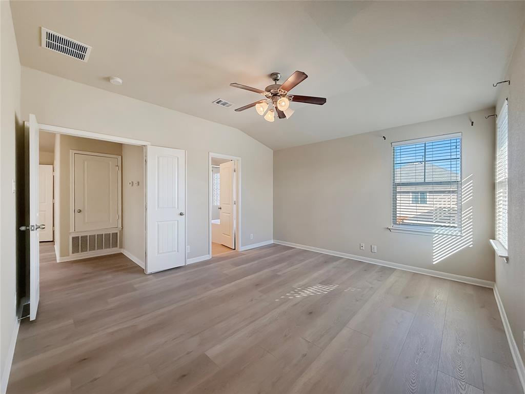 8505 Inca Dove Drive Austin, TX 78729 - Photo 18 of 30 This spacious room features light-colored flooring, a ceiling fan with integrated lighting, and walls painted in a neutral tone