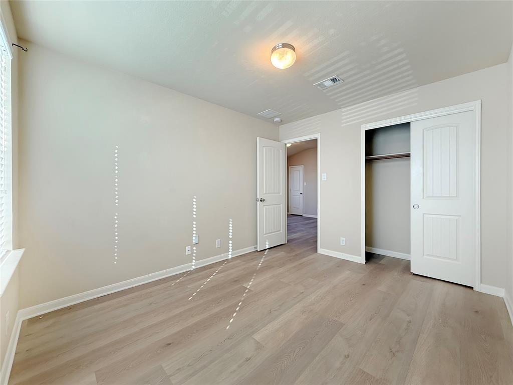 8505 Inca Dove Drive Austin, TX 78729 - Photo 23 of 30 This room features light-colored walls, light wood-look flooring, and a window with blinds