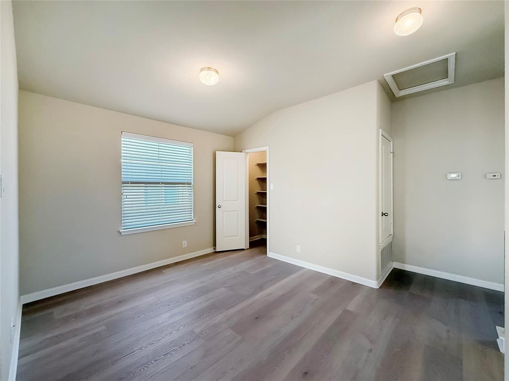 8505 Inca Dove Drive Austin, TX 78729 - Photo 25 of 30 This room features light-colored walls, recessed ceiling lighting, a window with blinds, and light wood-look flooring