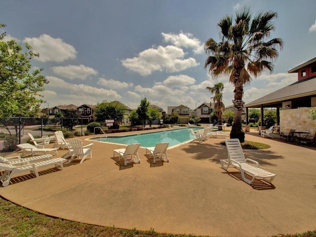 8505 Inca Dove Drive Austin, TX 78729 - Photo 30 of 30 The property features a swimming pool with a surrounding patio, offering ample space for recreation