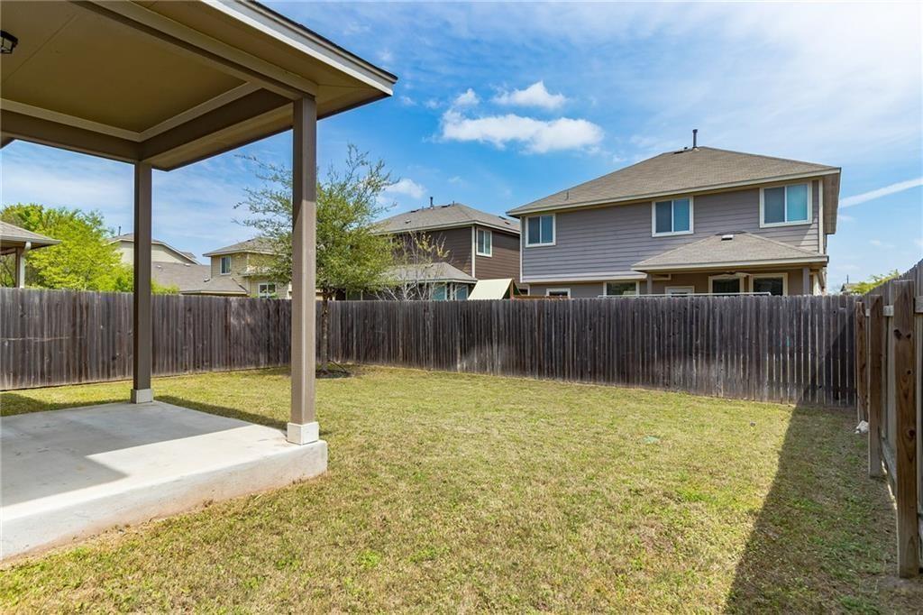 8505 Inca Dove Drive Austin, TX 78729 - Photo 9 of 30 The property features a private yard with a wooden fence and a covered patio area