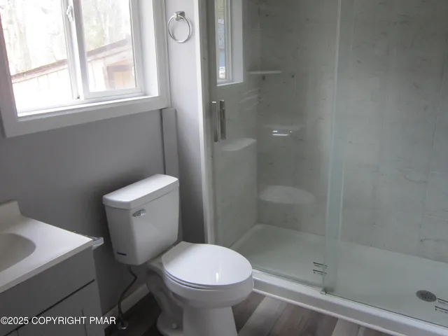 a white toilet sitting next to a bathroom sink