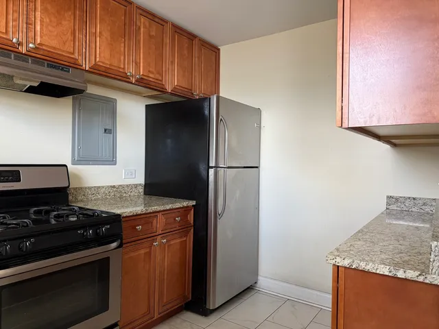 a kitchen with granite countertop cabinets and steel stainless steel appliances