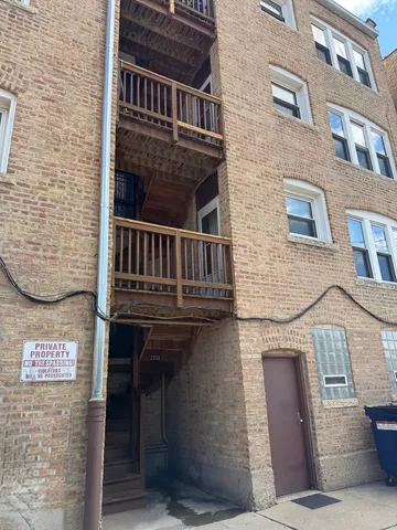 a view of a brick building with many windows