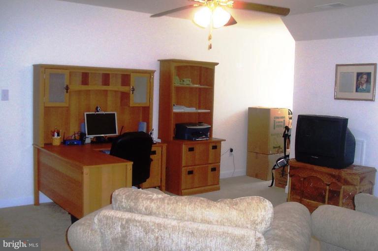277 Freezeland Loop Road Linden, VA 22642 - Photo 5 of 10 a bedroom with a bed and a television