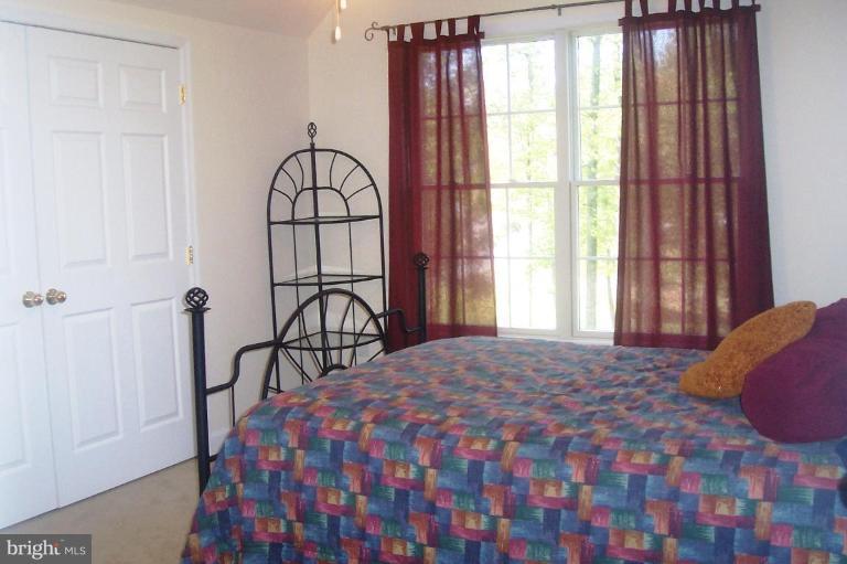 277 Freezeland Loop Road Linden, VA 22642 - Photo 8 of 10 a bedroom with a bed and a window