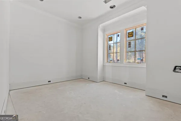 a living room with a floor to ceiling window and a rug
