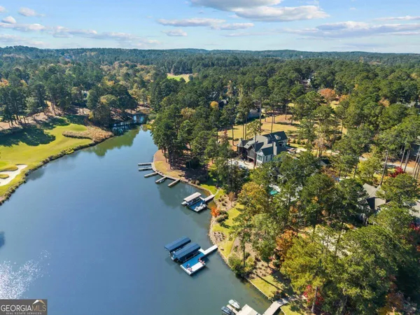 an aerial view of a house with a yard and lake view