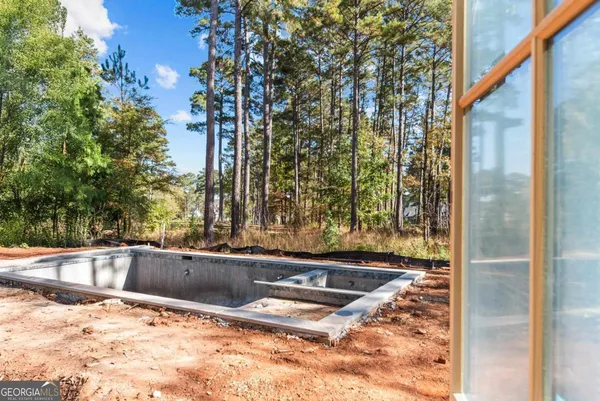 a view of swimming pool from a bathroom
