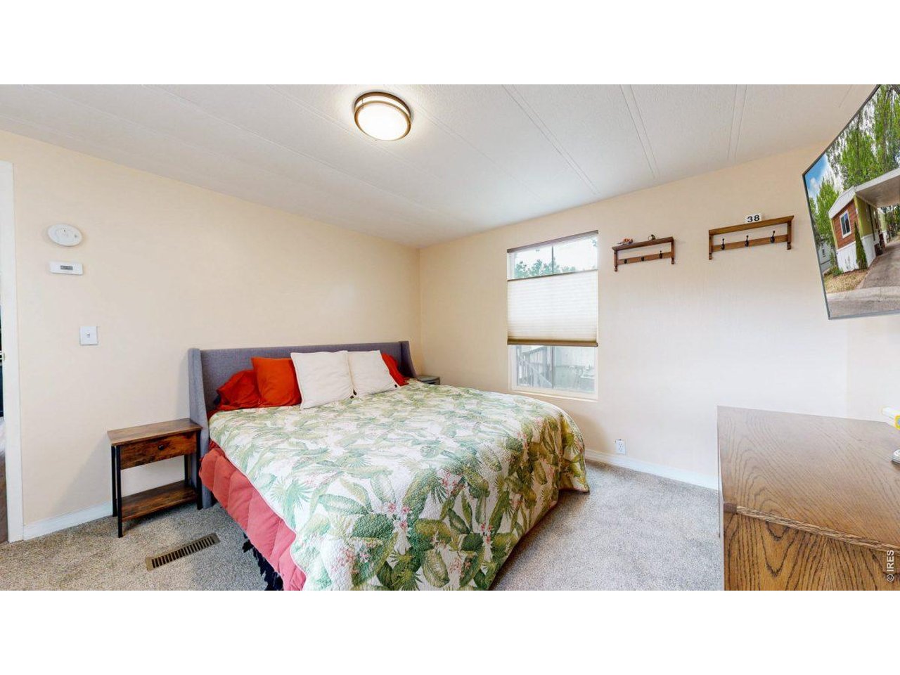 2500 East Harmony Road, Unit 18 Fort Collins, CO 80528 - Photo 17 of 41 a living room with a bed and a dresser