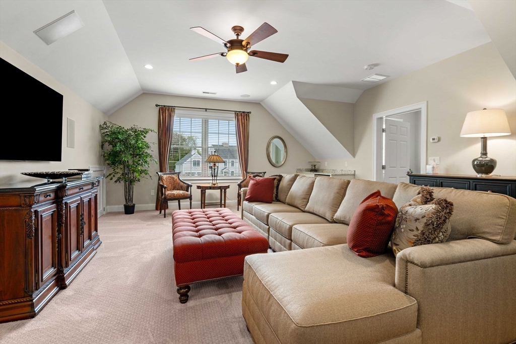 4 Point Shore Overlook Amesbury, MA 01913 - Photo 32 of 42 a living room with furniture a ceiling fan and a flat screen tv