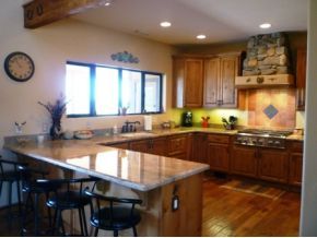 5000 Dillon Wash Road Prescott, AZ 86305 - Photo 3 of 12 a large kitchen with granite countertop a stove a sink a counter space and dining table