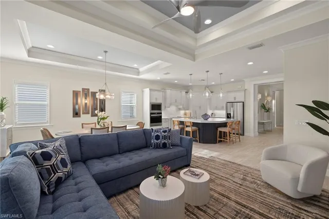 a living room with furniture and a dining table