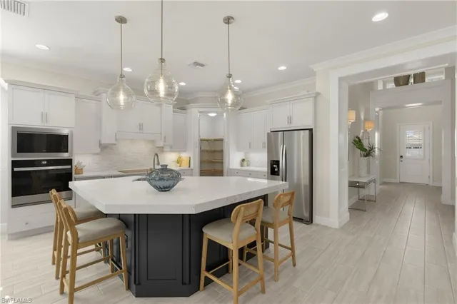 a view of a dining room and a kitchen with a table chairs
