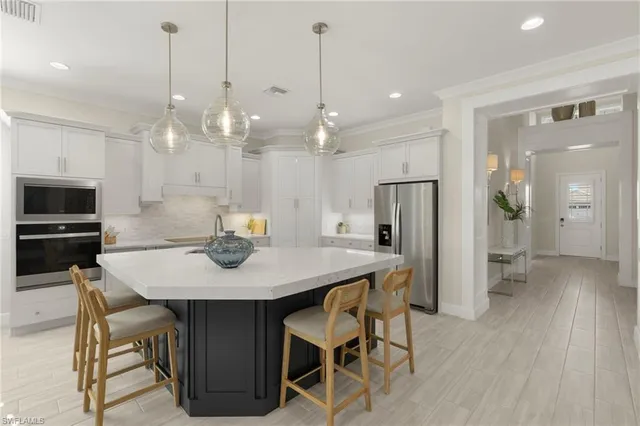 a view of a dining room and a kitchen with a table chairs