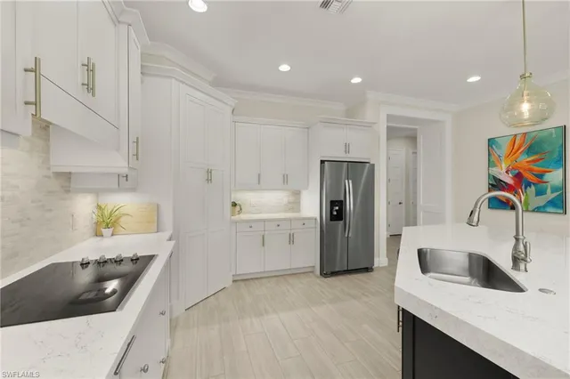 a kitchen with a sink a stove and refrigerator