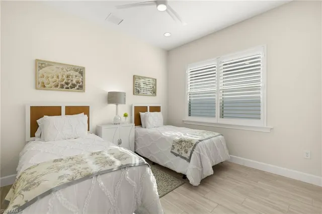 a bedroom with two beds and a window