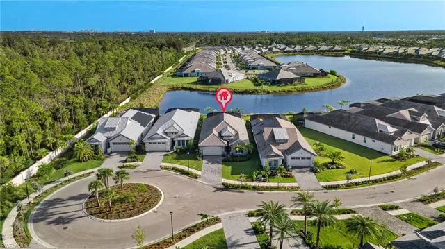 an aerial view of a house with swimming pool and lake view