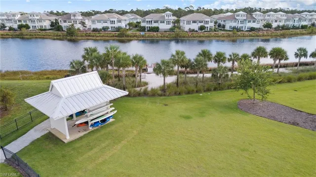 an aerial view of a house with a swimming pool a patio and yard