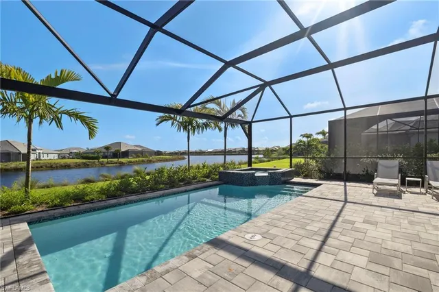 a view of swimming pool with a patio and a yard