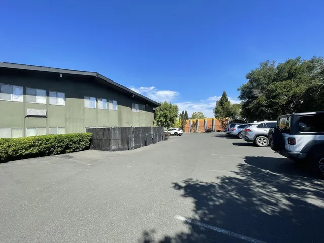 a view of a car park in front of a house
