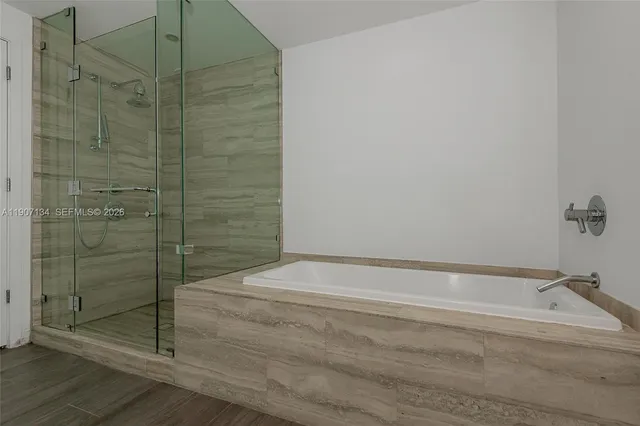 a view of a backyard with plants and patio