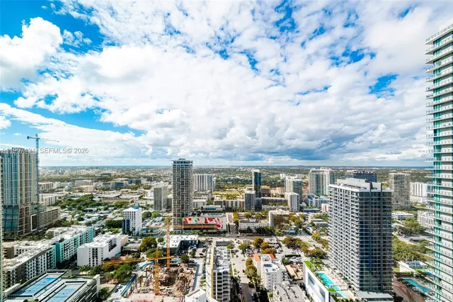 a front view of a building with outdoor seating and plants