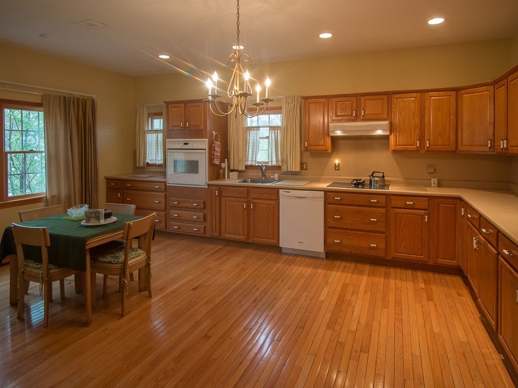 20 Davis Road Westminster, MA 01473 - Photo 5 of 25 a kitchen with stainless steel appliances granite countertop wooden floors and white cabinets