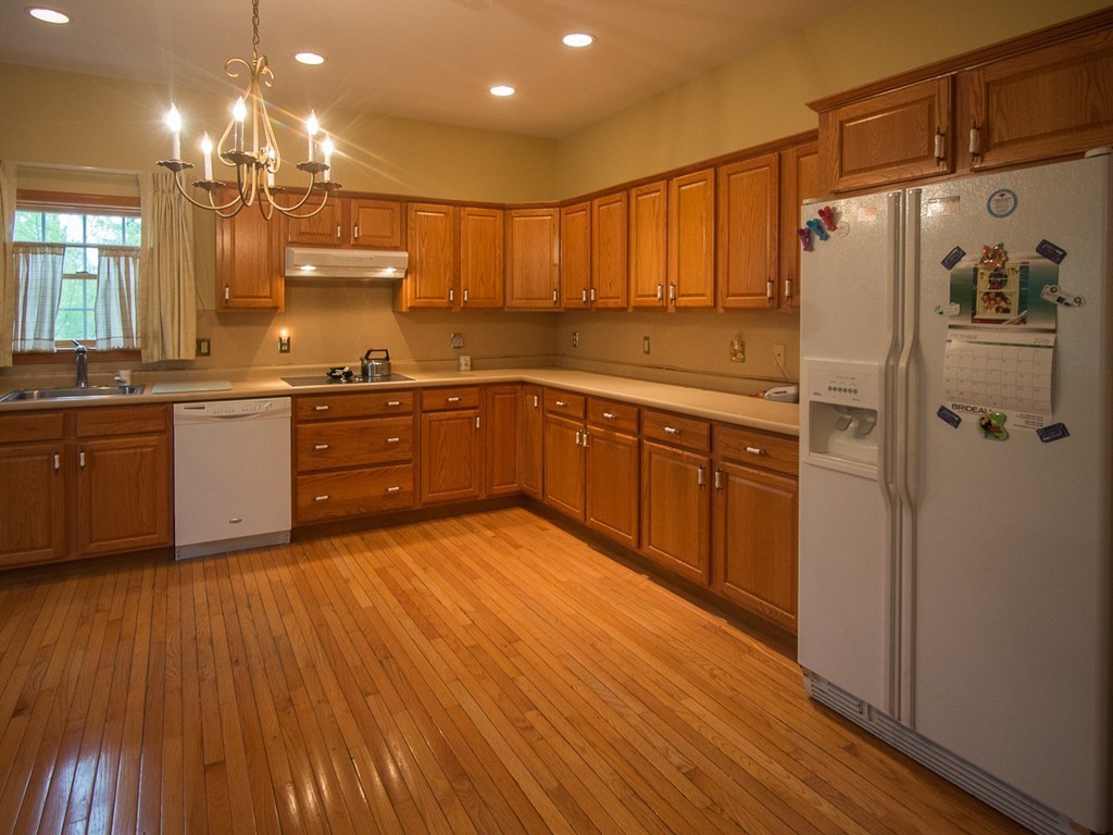20 Davis Road Westminster, MA 01473 - Photo 6 of 25 a large kitchen with stainless steel appliances granite countertop a refrigerator a sink dishwasher a stove and white countertops with wooden floor