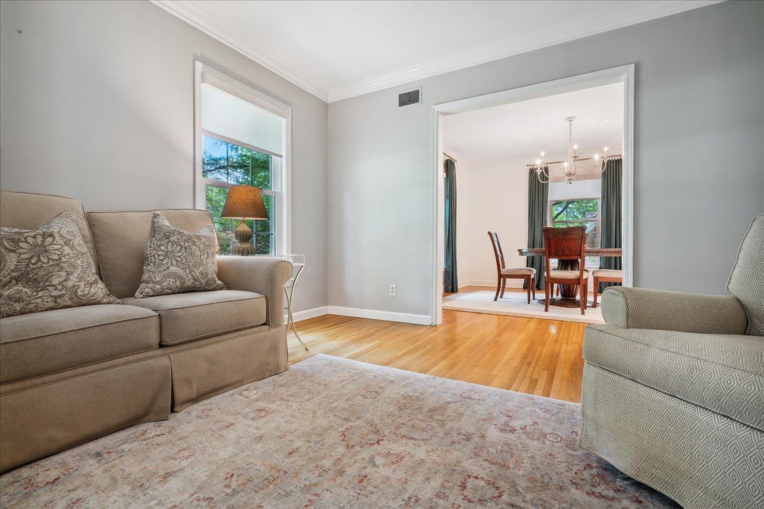 1141 Fair Meadow Road Memphis, TN 38117 - Photo 11 of 40 Living room with a notable chandelier, ornamental molding, a wealth of natural light, and hardwood / wood-style flooring