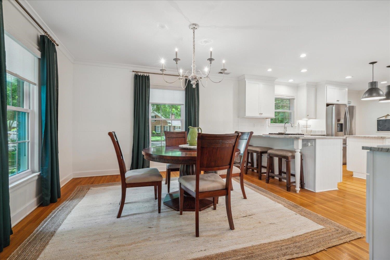 1141 Fair Meadow Road Memphis, TN 38117 - Photo 12 of 40 Dining area with sink, light hardwood / wood-style flooring, a healthy amount of sunlight, and a chandelier