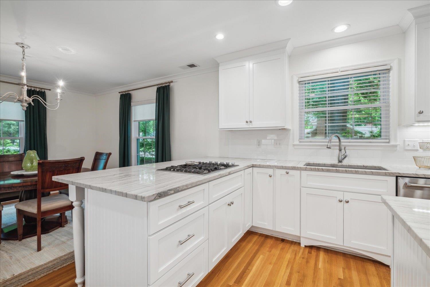 1141 Fair Meadow Road Memphis, TN 38117 - Photo 16 of 40 Kitchen featuring light hardwood / wood-style floors, sink, tasteful backsplash, and plenty of natural light