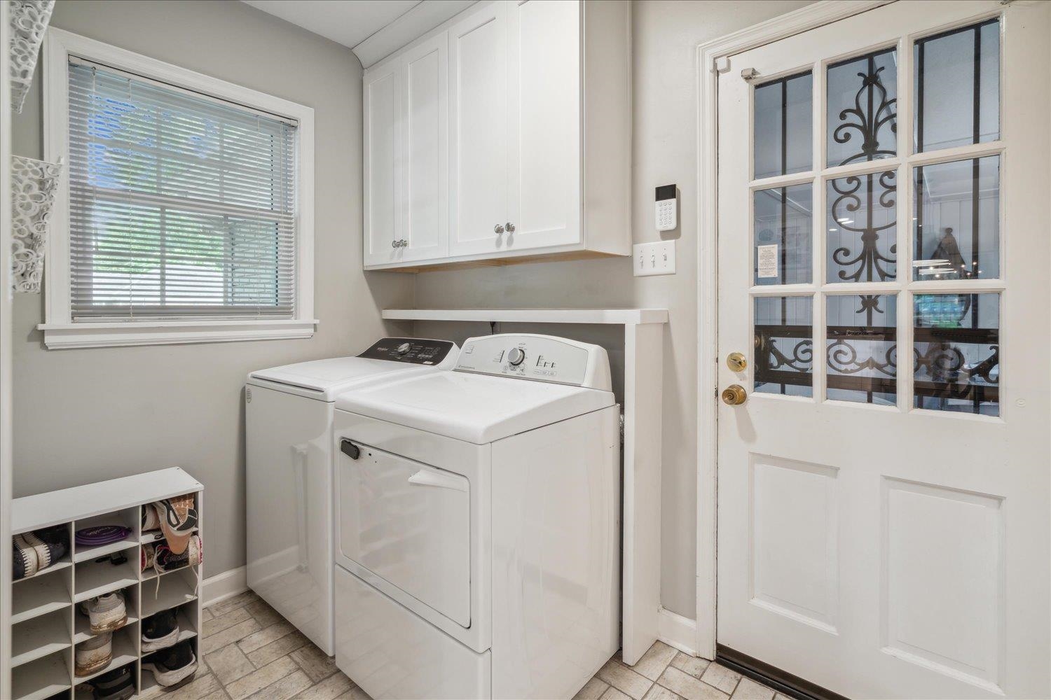 1141 Fair Meadow Road Memphis, TN 38117 - Photo 19 of 40 Laundry room with washer and clothes dryer and cabinets