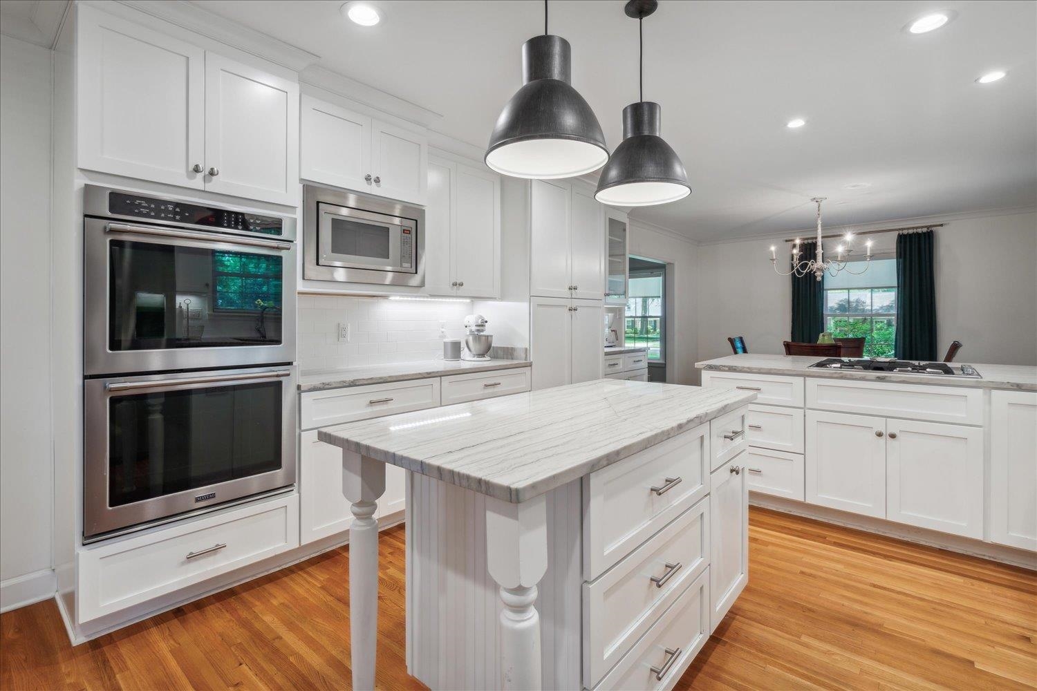 1141 Fair Meadow Road Memphis, TN 38117 - Photo 21 of 40 Kitchen featuring appliances with stainless steel finishes, tasteful backsplash, light hardwood / wood-style floors, light stone countertops, and ornamental molding