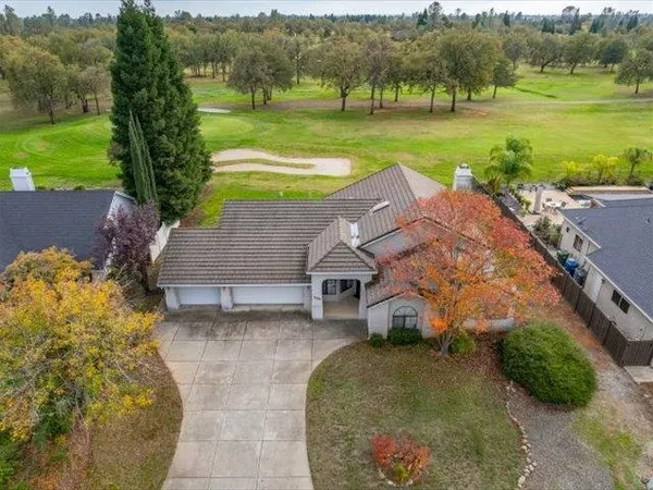 an aerial view of a house with big yard